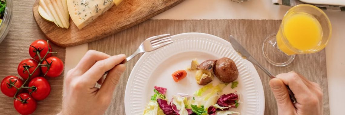 A vibrant lunch setting with salad, cheese, and orange juice, perfect for a healthy meal.